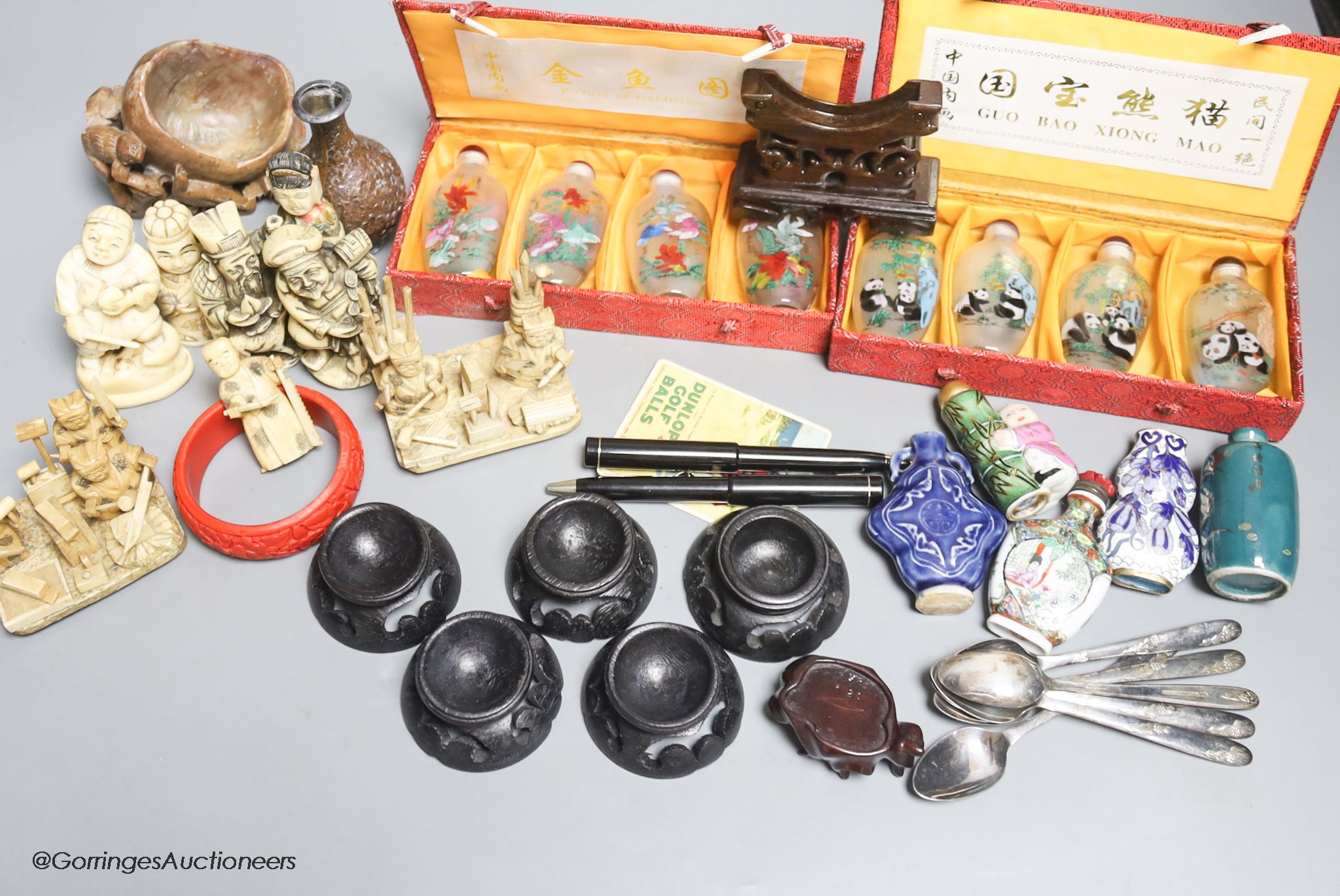 A collection of miscellaneous snuff bottles, figurative carvings, stands etc